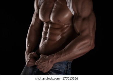 Strong Athletic Man Fitness Model Torso Showing Six Pack Abs. Isolated On Black Background