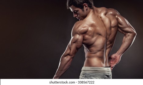 Strong Athletic Man Fitness Model Posing Back Muscles, Triceps, Latissimus With Copyspace