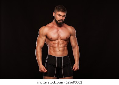 Strong Athletic Man Fitness Model Torso Showing Six Pack Abs. Isolated On Black Background With Copyspace