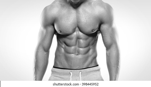 Strong Athletic Man  Showing Muscular Body And Sixpack Abs Over White Background