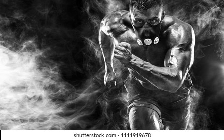 Strong athletic man sprinter in training mask, running, fitness and sport motivation. Runner concept with copy space. Dynamic movement.