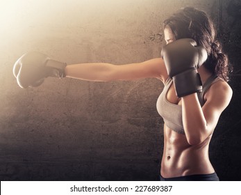 Strong Athletic Woman With Boxing Gloves Punching