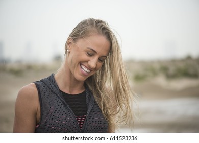 Strong Athletic Woman With Mud On Her Face After Running In Rain Or Extreme Sport 