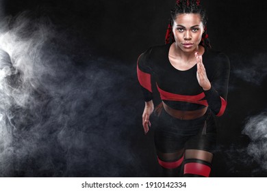 Strong Athletic Woman Sprinter, Running On Black Background Wearing In The Sportswear. Fitness And Sport Motivation. Runner Concept.