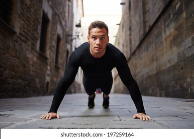 Strong attractive runner is pushed from the floor before morning jog