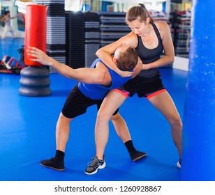 Strong Bold   Woman  Is Training Captures With Man On The Self-defense Course In Gym.