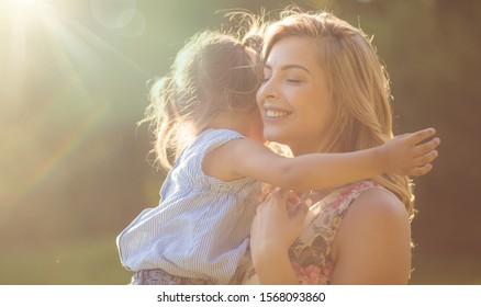 Strong Bond. Mother With Daughter In Nature.