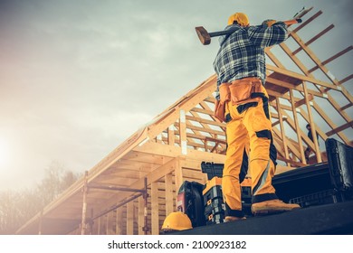 Strong Caucasian Construction Worker With A Large Hammer Ready For Tough Job Staying On His Pickup Truck Cargo Area. Construction Industry Theme.