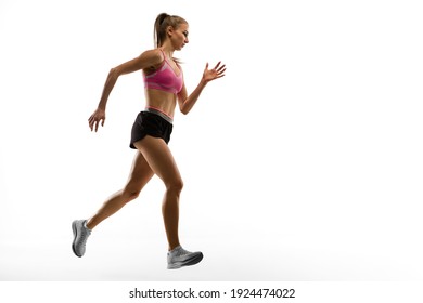 Strong. Caucasian Professional Female Athlete, Runner Training Isolated On White Studio Background. Muscular, Sportive Woman. Concept Of Action, Motion, Youth, Healthy Lifestyle. Copyspace For Ad.