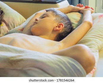 strong children's sleep. an adult boy is sleeping on a bed.