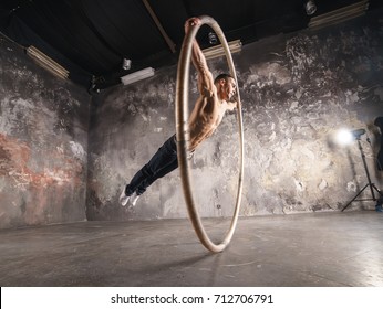 Strong Circus Performer Spinning In The Cyr Wheel