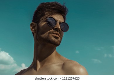 Strong Commercial Face Male Model  Wearing Eyewear On Blue Sky With Clouds 