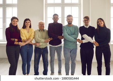 Strong Community, Good Relationship, Mutual Help And Support. Group Portrait Of Happy Diverse People Looking At Camera. Smiling Members Of International Friendship Club Standing Together Holding Hands