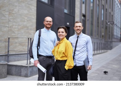 Strong Confident Professional Group Of Business Persons Standing Outside. Caucasian Team Of Young Male And Female Business Executives. Finance, Real Estate Or Construction Industry Concept