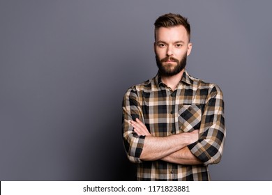 Strong, confident, strict man in casual checkered shirt cross arms over chest and look at camera isolated on gray background with copy space for text - Powered by Shutterstock