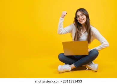 Strong confident woman, full body view of strong confident woman. Female boss concept idea. Showing biceps, looking smiling with proud. Feeling success and power. Yellow background studio shot.  - Shutterstock ID 2311331433