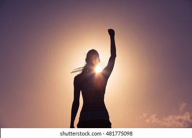 Strong confident woman with her fist up in the air.  - Shutterstock ID 481775098