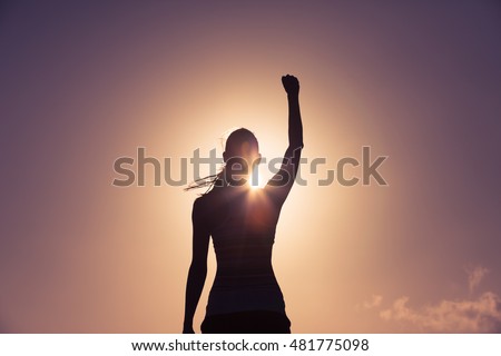 Strong confident woman with her fist up in the air. 