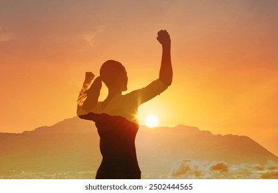 Strong confident woman, winning, success , and life goals concept. Young woman with arms flexed looking up to the sky. - Powered by Shutterstock