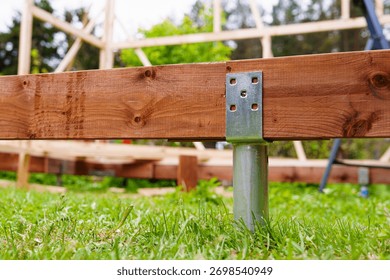 A strong deck foundation under construction with a ground screw and wood frame support. This stable base is ideal for outdoor projects and showcases effective building techniques.