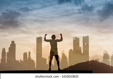 Strong, determined young man standing in the city with arms flexed. Feeling motivated and never giving up concept. Double exposure.  - Powered by Shutterstock