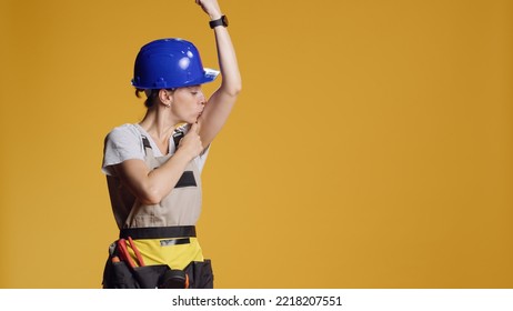 Strong Empowered Woman Flexing Arm Muscles In Studio, Preparing To Work On Construction Refurbishment With Tools. Confident Powerful Handywoman Pointing At Biceps And Triceps.