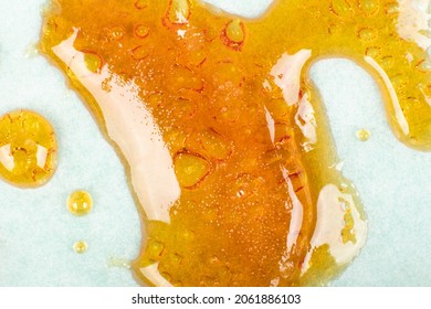 strong extract of gold cannabis wax with high thc close up	
