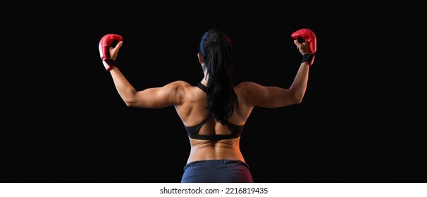 Strong female boxer on dark background, back view - Powered by Shutterstock