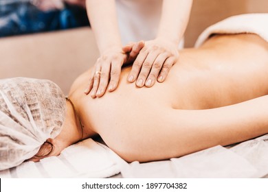 Strong Female Hands Of Masseur During Massage Session - Manual Therapy Of Woman Back