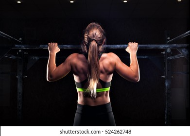 Strong Fit Girl In Sportswear Doing Pull Up Exercise On Horizontal Bar. Fitness Workout In Gym.