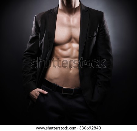Strong, fit and sporty stripper man over black background. Foto d'archivio © 