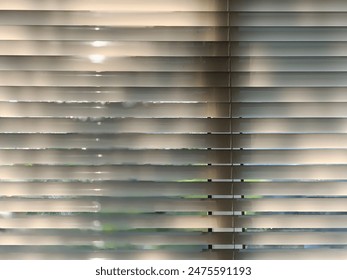 a strong geometric composition due to the repetitive lines of the blinds - Powered by Shutterstock