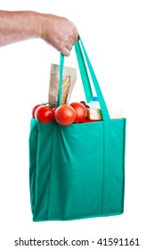 A Strong Hand Holding An Environmentally Friendly Bag Full Of Groceries.  Shot On White Background.