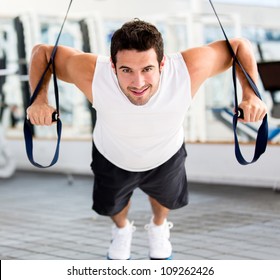 Strong Handsome Man Exercising At The Gym