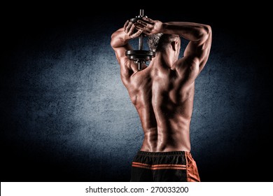 strong and handsome young man doing exercise with dumbbells - Powered by Shutterstock