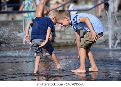 Strong heat in the city: boys playing with fountain water jets at the square. June 5, 2019. Kiev, Ukraine - Shutterstock ID 1489835570
