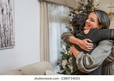 Strong hug between friends in a Christmas atmosphere. - Powered by Shutterstock