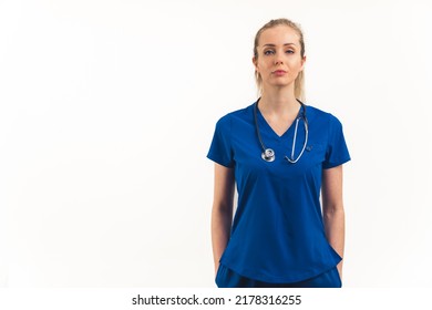 Strong, Independent, Powerful And Professional Caucasian Woman As A Healthcare Worker - Nurse, Doctor, Specialist, Standing In A Dark Blue Uniform And Looking At Camera With Confidence. White