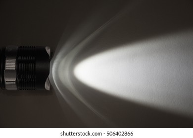 Strong Light Source From Flashlight In The Dark. Flashlight Beam