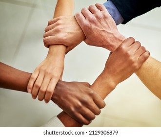 Strong Links Create Strong Teams. Cropped Shot Of A Group Of Businesspeople Linking Their Arms In Solidarity.