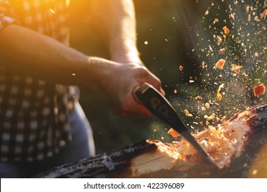 Strong lumberjack chopping wood, chips fly apart - Powered by Shutterstock