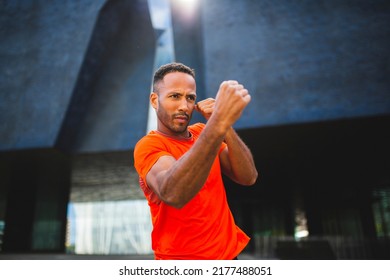 Strong male boxer practicing boxing by throwing punches in the air - Powered by Shutterstock