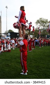 Strong Male Cheerleader Lifting A Female