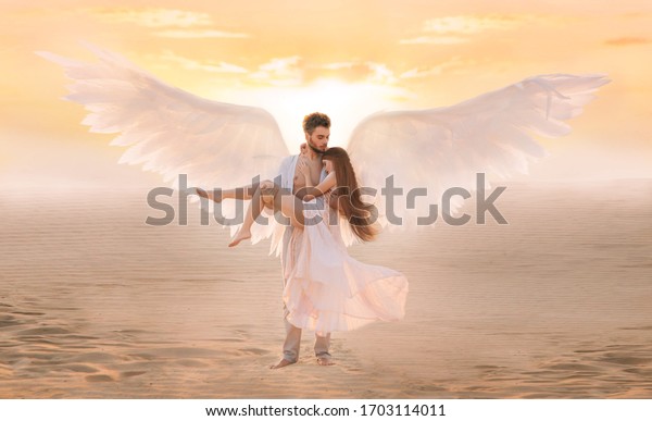Strong male costume angel holds hug fragile\
innocent woman in arms. concept protection prayer security helper\
keeper love faith help religion. art sunset sky in desert. Girl and\
handsome man embracing