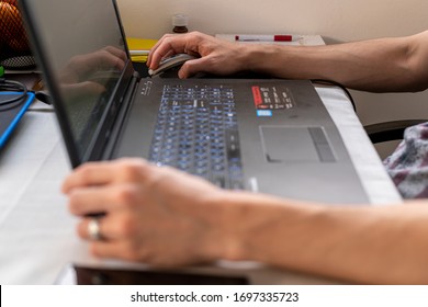 Strong Male Hands, Keyboard And Laptop. Remote Work From Home During Quarantine, Isolation, Illness. Online Conferences, Consultations Or Training. The Concept Of Protection, Safety And Health. Home.