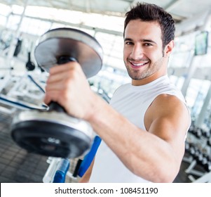 Strong Man At The Gym Lifting Weights