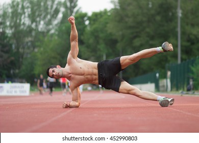 Strong Man Red Running Track Side Plank Leg Arm Up Raised