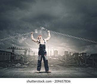 Strong man in uniform tearing metal chain with hands