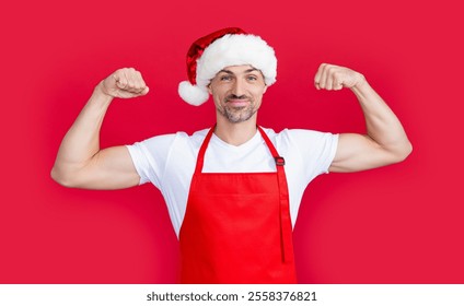 strong mature man in red barista apron and christmas santa hat - Powered by Shutterstock