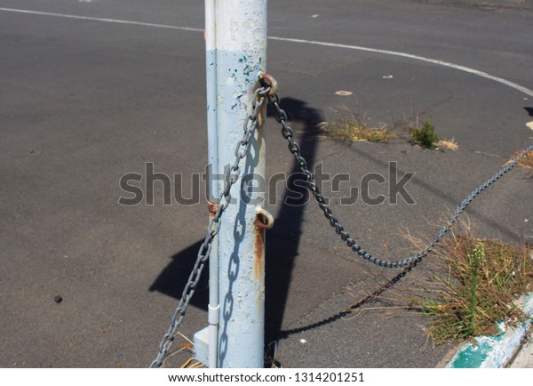 Strong metal chain used with\
metal poles  and  locks to secure car yards at night  against\
thieves .